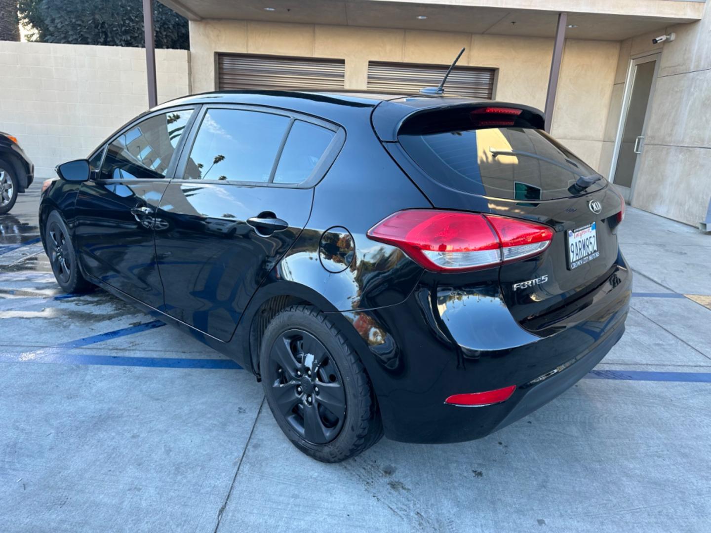 2016 Black /Black Kia Forte 5-Door Cloth (KNAFK5A87G5) with an 4 CYLINDER engine, Automatic transmission, located at 30 S. Berkeley Avenue, Pasadena, CA, 91107, (626) 248-7567, 34.145447, -118.109398 - Embark on a Journey of Style and Efficiency with the 2016 Kia Forte Hatch - Now Available at Our Premier Pasadena, CA Dealership Welcome to our BHPH dealership in Pasadena, CA, where we proudly present the 2016 Kia Forte Hatch, a vehicle that seamlessly blends stylish design, modern technology, a - Photo#2